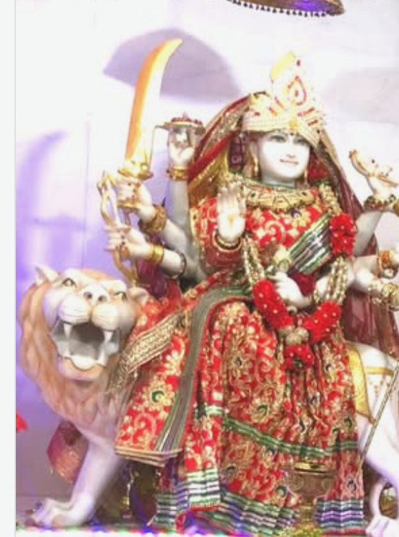 Durga Maa on her lion — the temple's own murti, adorned for Navratri